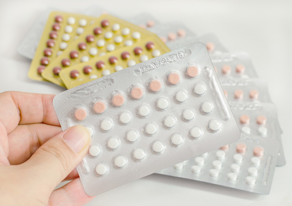woman hand holding contraceptive pills